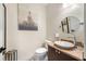 Powder room featuring a modern vessel sink, marble countertop, and decorative art at 5812 Mariners Watch Dr, Tampa, FL 33615