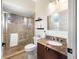 Bathroom featuring a shower with glass door and granite countertop vanity at 5812 Mariners Watch Dr, Tampa, FL 33615