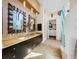 Bathroom with double granite vanity and a door to the spacious walk-in closet at 5812 Mariners Watch Dr, Tampa, FL 33615