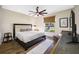 Bedroom with hardwood floors, a king-size bed, a window with a view of the outdoors, and a ceiling fan at 5812 Mariners Watch Dr, Tampa, FL 33615
