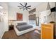 Bedroom featuring a ceiling fan, hardwood floors, and a window with natural light at 5812 Mariners Watch Dr, Tampa, FL 33615