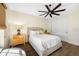Bright bedroom featuring hardwood floors, a ceiling fan, and a comfortable upholstered bed at 5812 Mariners Watch Dr, Tampa, FL 33615