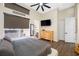 Bedroom with hardwood floors, ceiling fan, a window, and an ensuite bathroom at 5812 Mariners Watch Dr, Tampa, FL 33615