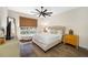 Bedroom with a queen-size bed, hardwood floors, and a window with natural lighting and a view to the outside at 5812 Mariners Watch Dr, Tampa, FL 33615