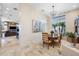 Open dining area showcases artwork, tile floors and views to the backyard at 5812 Mariners Watch Dr, Tampa, FL 33615