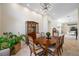 Formal dining room features elegant chandelier, a classic wooden dining table and views of other living spaces at 5812 Mariners Watch Dr, Tampa, FL 33615