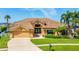 Stunning single-Gathering home with well-manicured lawn, elegant landscaping and a driveway at 5812 Mariners Watch Dr, Tampa, FL 33615