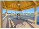Interior view of gazebo on waterfront, showcasing benches and ceiling fan at 5812 Mariners Watch Dr, Tampa, FL 33615