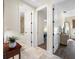 Hallway with travertine flooring and views to a bathroom and bedroom at 5812 Mariners Watch Dr, Tampa, FL 33615