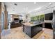 Open-concept kitchen featuring a large island, modern appliances, and an adjacent living area at 5812 Mariners Watch Dr, Tampa, FL 33615