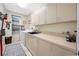 Practical laundry room with countertops, cabinets, and modern appliances at 5812 Mariners Watch Dr, Tampa, FL 33615