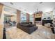 Spacious living room features large sectional sofa, fireplace, and access to the outdoor patio at 5812 Mariners Watch Dr, Tampa, FL 33615