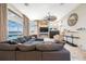 Bright living room features large windows, a modern fan, and comfortable seating area at 5812 Mariners Watch Dr, Tampa, FL 33615