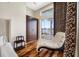 Main bedroom featuring a chaise lounge, hardwood floors, and waterfront views at 5812 Mariners Watch Dr, Tampa, FL 33615