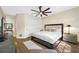 Main bedroom features a king-size bed, wood flooring, and a view of the hallway at 5812 Mariners Watch Dr, Tampa, FL 33615