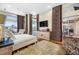 Main bedroom featuring pool views, hardwood floors, and large windows with decorative curtains at 5812 Mariners Watch Dr, Tampa, FL 33615
