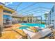 Screened-in pool with spa and travertine tile deck, perfect for outdoor living at 5812 Mariners Watch Dr, Tampa, FL 33615