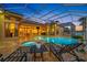 The screened pool area features a spa, an outdoor kitchen and plenty of room for lounging at 5812 Mariners Watch Dr, Tampa, FL 33615