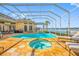 Gorgeous in-ground screened pool and spa, with outdoor seating and a barbecue area at 5812 Mariners Watch Dr, Tampa, FL 33615