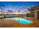 Gorgeous screened-in pool and spa area with lush landscaping and stunning waterfront views, perfect for relaxation and entertainment at 5812 Mariners Watch Dr, Tampa, FL 33615