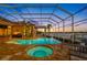 Expansive screened-in pool area featuring a spa, comfortable seating, and stunning waterfront views, perfect for entertaining at 5812 Mariners Watch Dr, Tampa, FL 33615