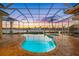 Inviting screened-in pool area with clear blue water, perfect for year-round enjoyment and showcasing waterfront views at 5812 Mariners Watch Dr, Tampa, FL 33615