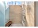 Walk-in shower featuring multiple shower heads, a bench, and travertine walls at 5812 Mariners Watch Dr, Tampa, FL 33615