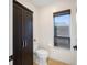 Comfortable toilet room featuring a window, tile floors, and a cabinet at 5812 Mariners Watch Dr, Tampa, FL 33615