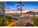 Beautiful waterfront view featuring a private dock, boat lift, and charming gazebo perfect for relaxation and enjoying the sunset at 5812 Mariners Watch Dr, Tampa, FL 33615