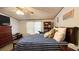 Bedroom with a blue striped comforter, bookshelf, and ceiling fan at 6051 106Th N Ave, Pinellas Park, FL 33782