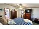 Inviting bedroom with blue striped bedding, ceiling fan and spacious walk ways at 6051 106Th N Ave, Pinellas Park, FL 33782