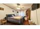 Cozy bedroom with wood floors, a comfortable bed, rug and ample storage with bookshelf at 6051 106Th N Ave, Pinellas Park, FL 33782