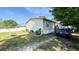 View of the single-story home featuring a well-maintained exterior, manicured landscaping, and convenient parking at 6051 106Th N Ave, Pinellas Park, FL 33782