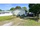 Charming single-story home with a spacious yard and a convenient driveway for easy parking and landscaped greenery at 6051 106Th N Ave, Pinellas Park, FL 33782