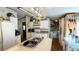 Bright kitchen with an island, white cabinetry, modern appliances, and functional layout with a laundry area at 6051 106Th N Ave, Pinellas Park, FL 33782