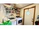 Practical laundry area with modern washer and dryer set and storage shelving at 6051 106Th N Ave, Pinellas Park, FL 33782