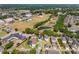 This aerial photo highlights the house's location and manicured lawn near a large pond at 6111 Hadley Commons Dr, Riverview, FL 33578