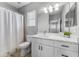 Bright bathroom features white cabinetry, a modern vanity, a toilet and a shower with curtain at 6111 Hadley Commons Dr, Riverview, FL 33578