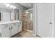Well-lit bathroom boasts a walk-in glass shower, white vanity, and a neutral color palette at 6111 Hadley Commons Dr, Riverview, FL 33578