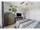 Bright bedroom with modern furnishings, including a dresser, TV stand, and stylish decor at 6111 Hadley Commons Dr, Riverview, FL 33578