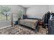 Inviting bedroom with a comfortable rug, a standing mirror, and ample natural light at 6111 Hadley Commons Dr, Riverview, FL 33578