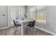 Cozy dining area with a white table, comfortable chairs and lots of natural light at 6111 Hadley Commons Dr, Riverview, FL 33578