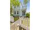 Charming two-story home featuring a picket fence, inviting entrance and lush landscaping at 6111 Hadley Commons Dr, Riverview, FL 33578