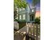 Charming two-story home featuring a picket fence, inviting entrance and lush landscaping at 6111 Hadley Commons Dr, Riverview, FL 33578