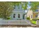 Charming two-story home featuring a picket fence, inviting entrance and lush landscaping at 6111 Hadley Commons Dr, Riverview, FL 33578