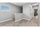 Upstairs hallway with lots of natural light and doors to bedrooms at 6111 Hadley Commons Dr, Riverview, FL 33578