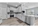 Modern kitchen with stainless steel appliances, white cabinetry, and a breakfast bar at 6111 Hadley Commons Dr, Riverview, FL 33578
