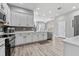 Spacious kitchen featuring modern appliances, stylish backsplash and ample cabinet space at 6111 Hadley Commons Dr, Riverview, FL 33578