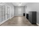 Spacious living room featuring wood floors, a ceiling fan, and French doors at 6111 Hadley Commons Dr, Riverview, FL 33578