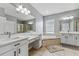 Spa-like main bathroom featuring dual vanities, soaking tub, and separate shower at 6111 Hadley Commons Dr, Riverview, FL 33578